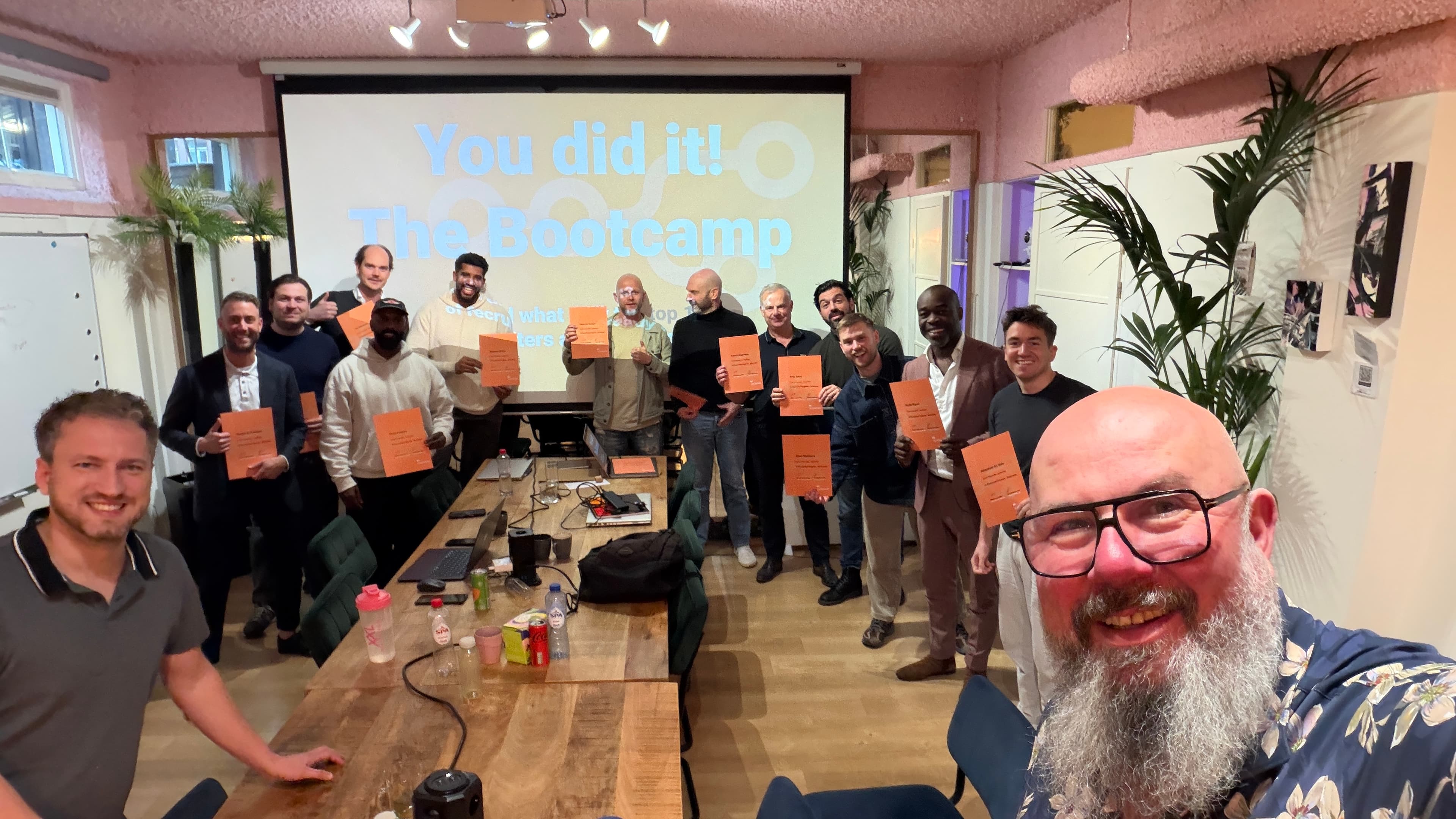 Bootcamp graduates holding their AI Recruitment Engineer certificates